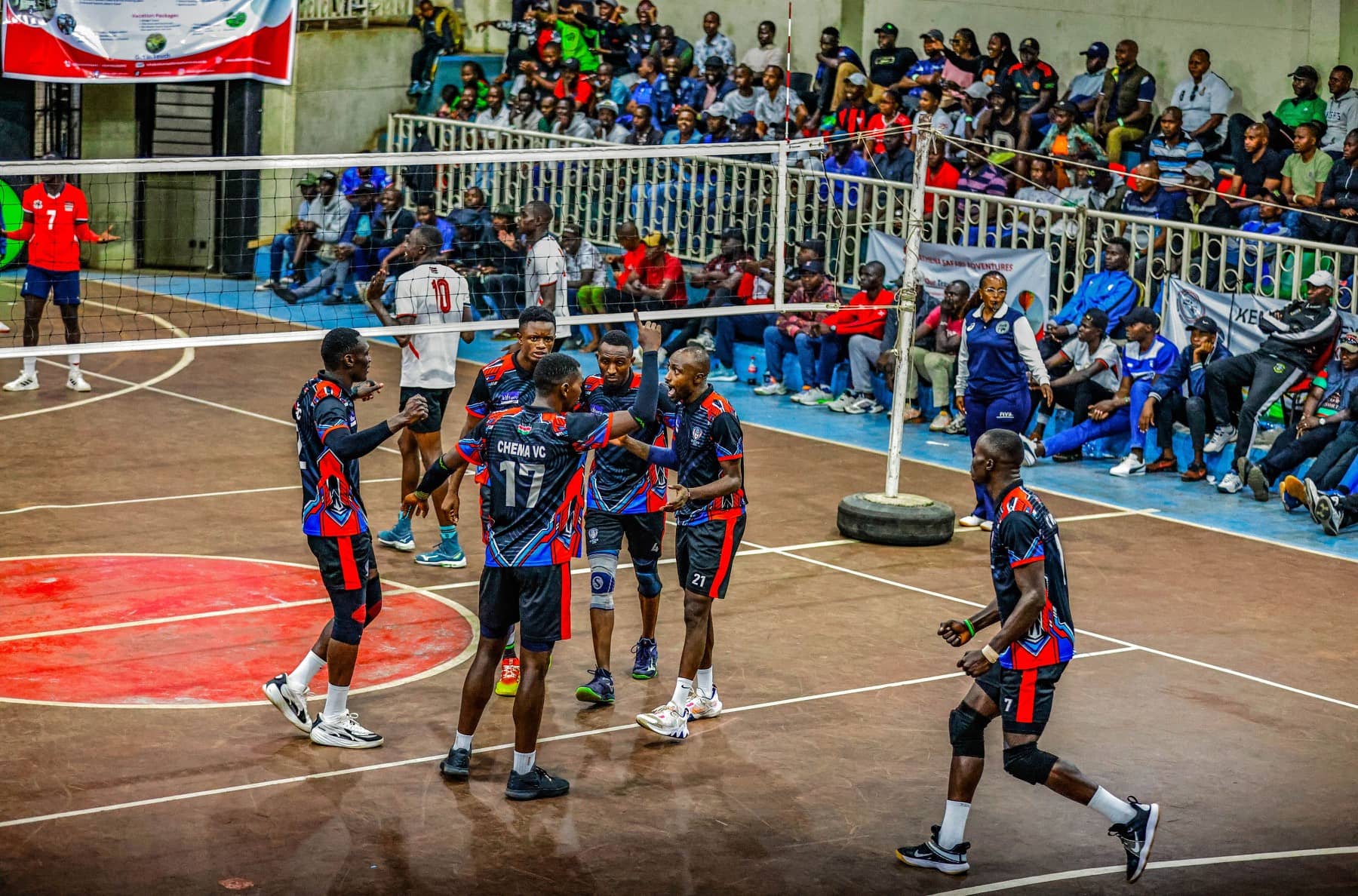 Chema VC players communicating at midcourt