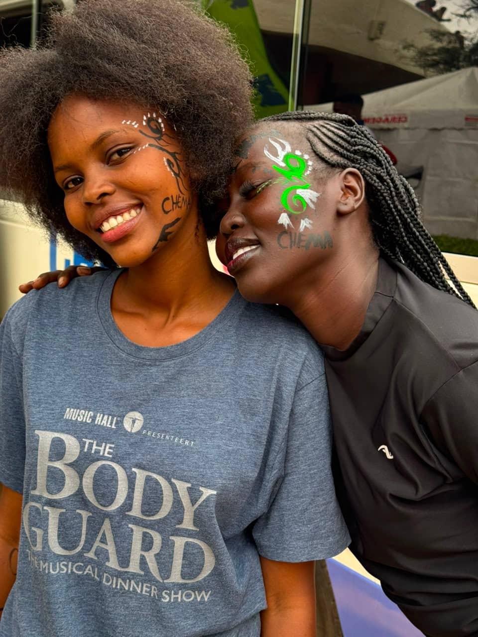 Two Chema supporters show off face paint and club pride at Kasarani.